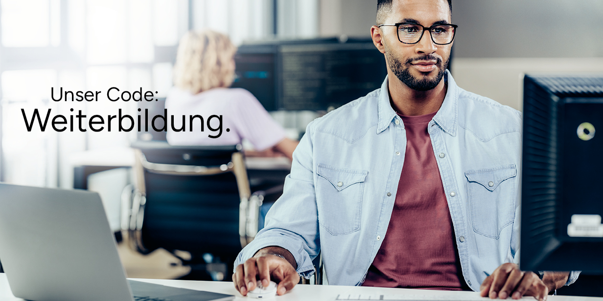 Ein Mann schaut auf eine Bildschirm und hat PC-Maus, Tastatur und Laptop vor sich auf dem Tisch stehen. Im Hintergrund schaut eine Frau auf drei Bildschirme.